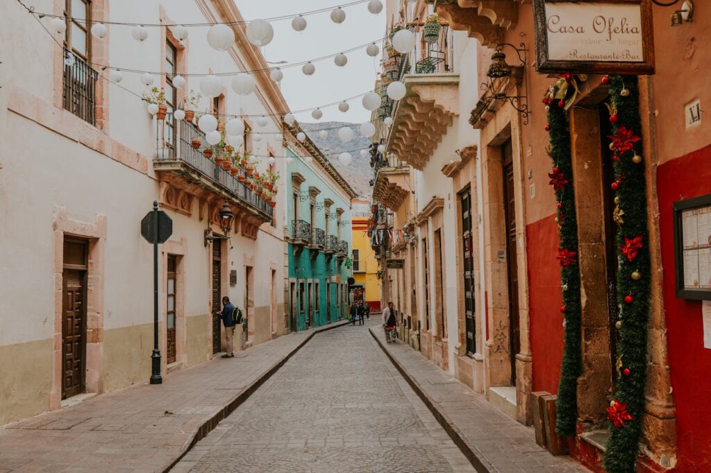 A narrow street with colorful buildings and decorations